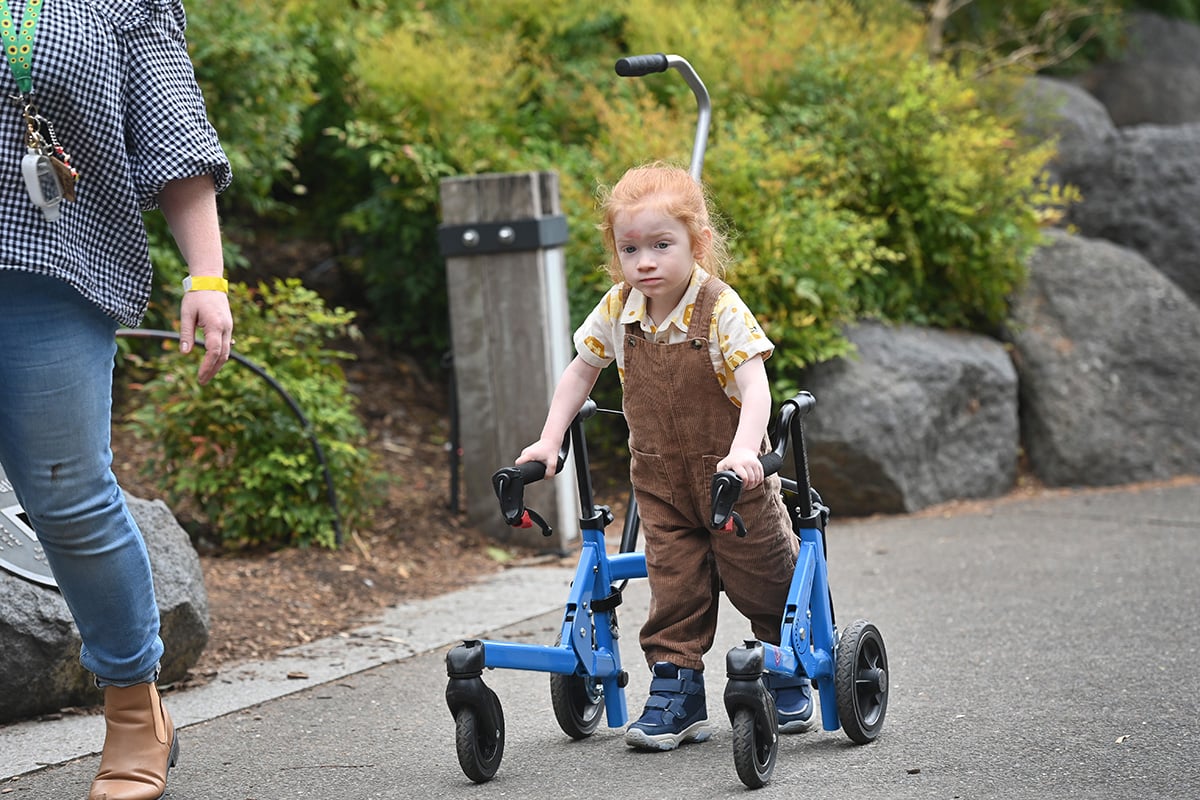 grant recipient with their new walker frame with mum by their side