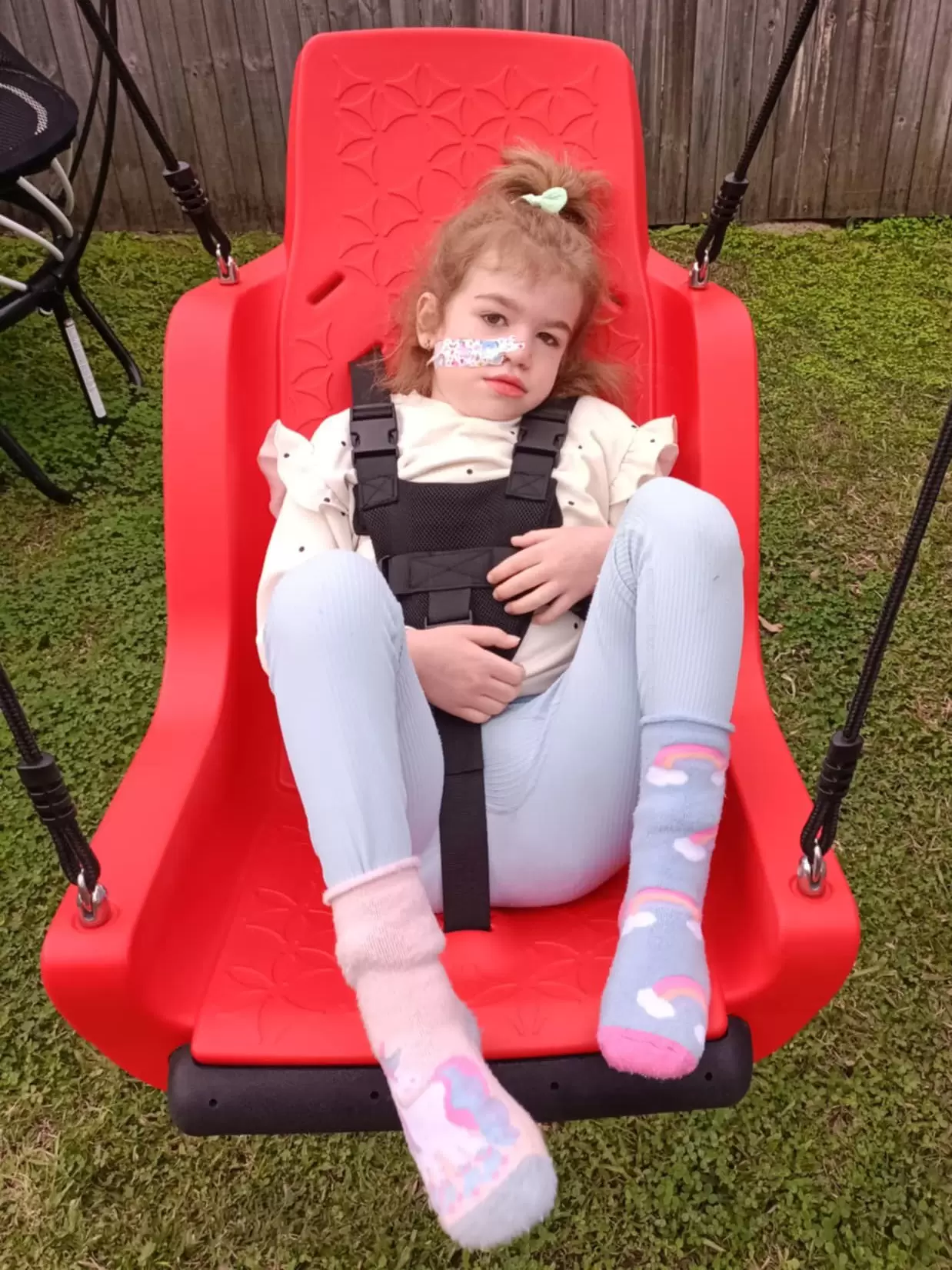 Grant Recipient Sophia happy in her name supportive swing